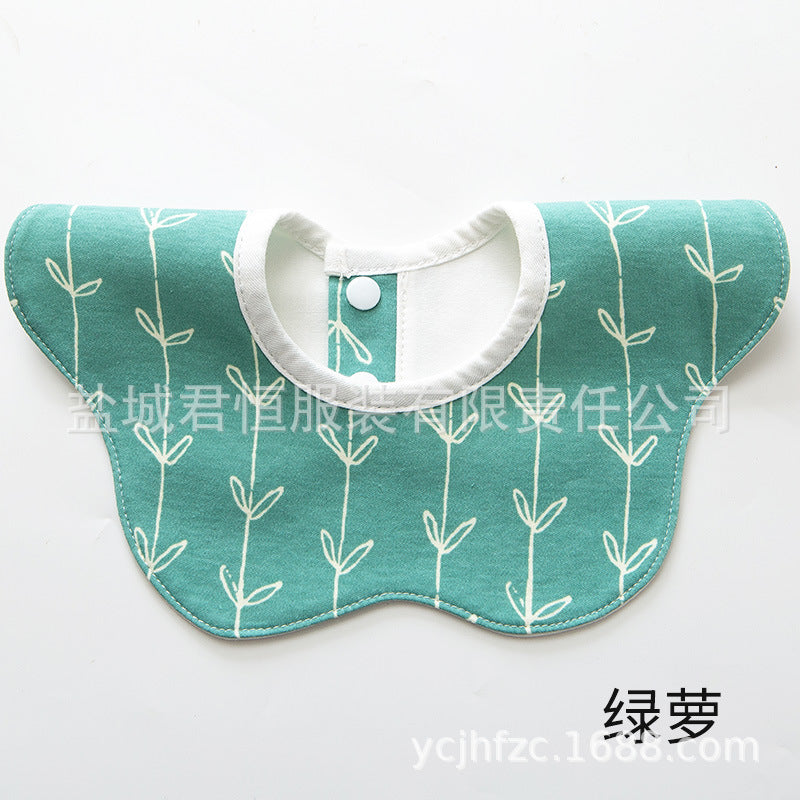 Teal bib with white leaf pattern on a white background