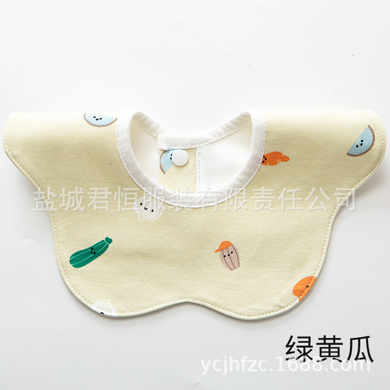 Baby bib with cartoon vegetable designs on a white background
