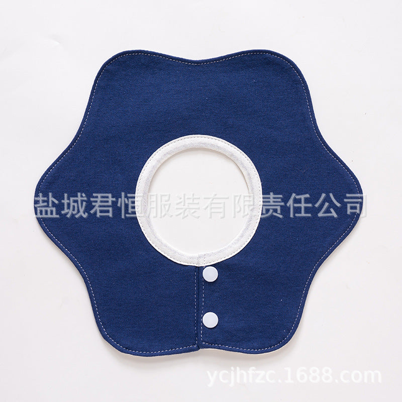 Blue denim collar with white button on a light gray background