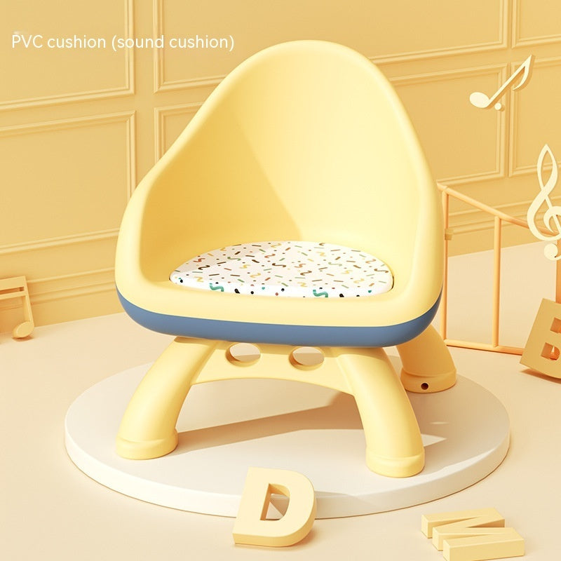 Yellow children's chair with a patterned cushion on a light wooden floor.