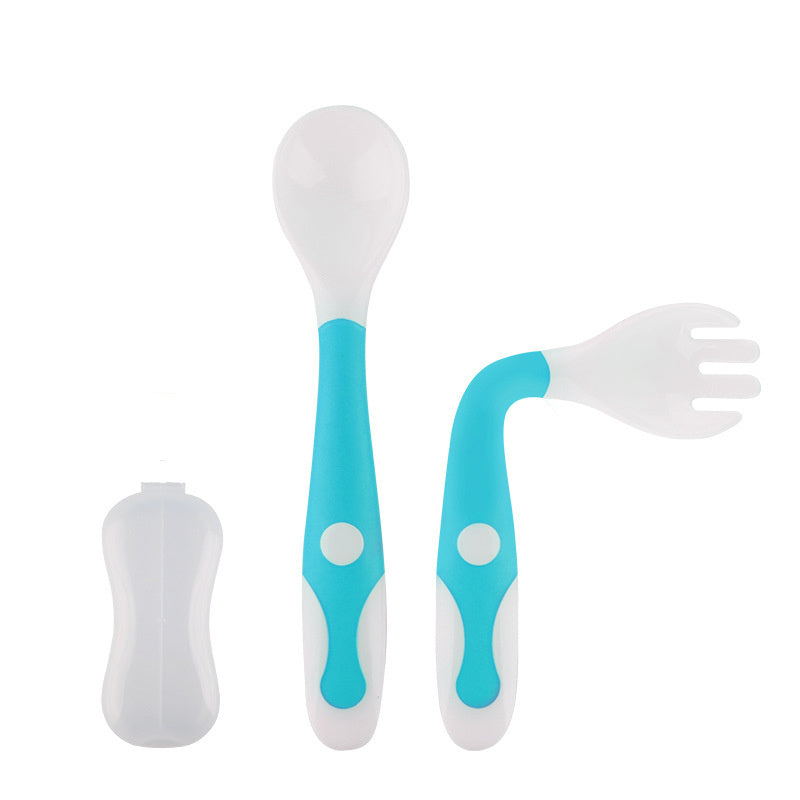 Set of baby utensils including a spoon and fork with turquoise handles on a white background
