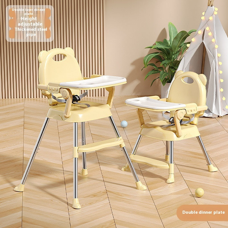 Height-adjustable baby high chair with tray on a wooden floor.