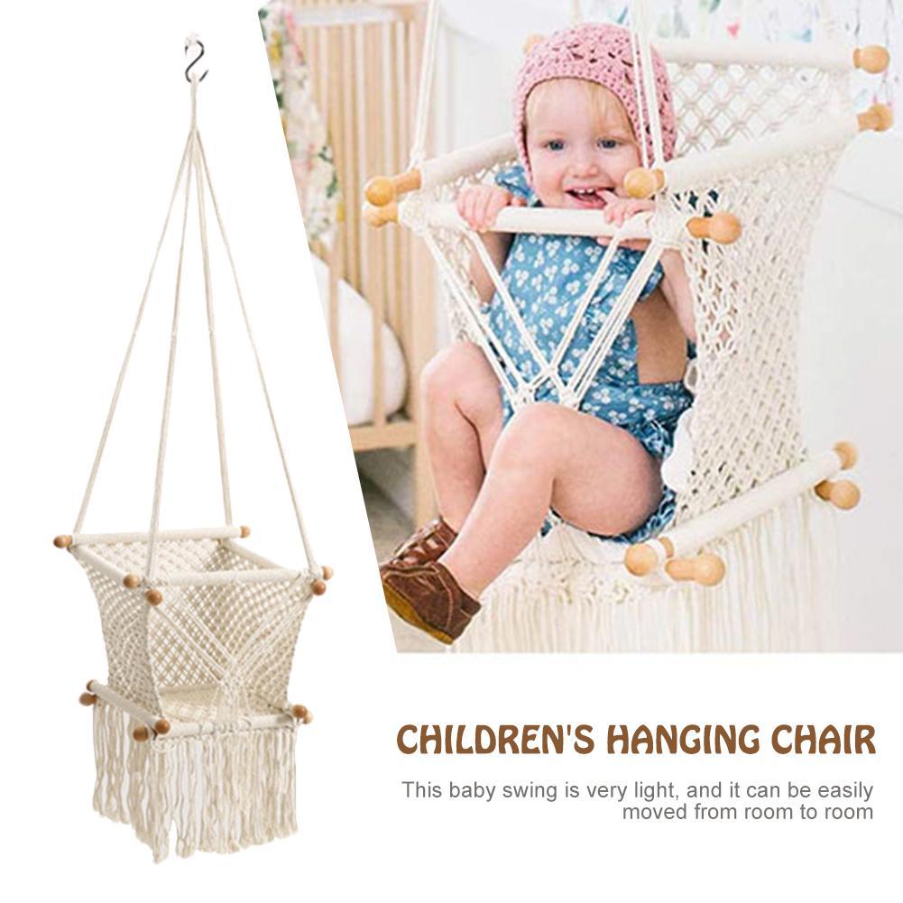 Children's hanging chair with a baby sitting in it, on a white background.