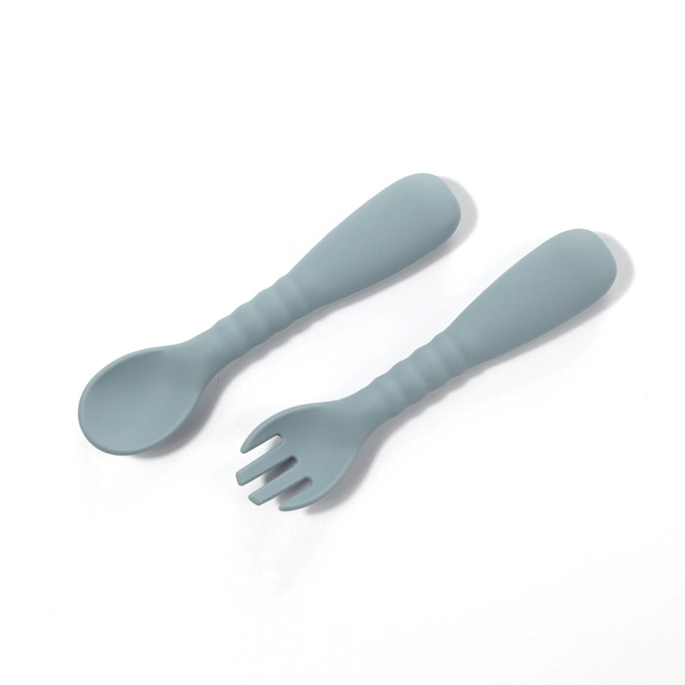 Set of light blue spoon and fork on a white background