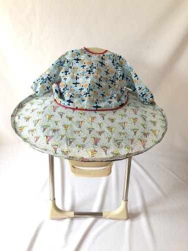 Baby bouncer with colorful airplane pattern on a white background
