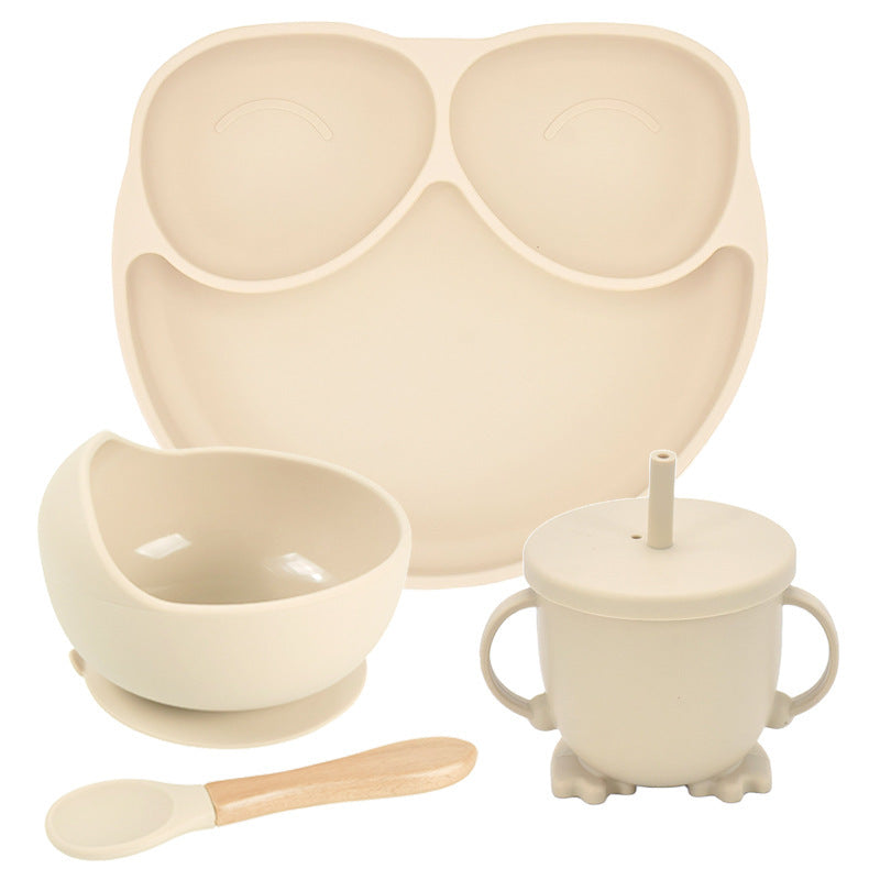 Beige children's dining set with plate, bowl, cup, and spoon on a white background