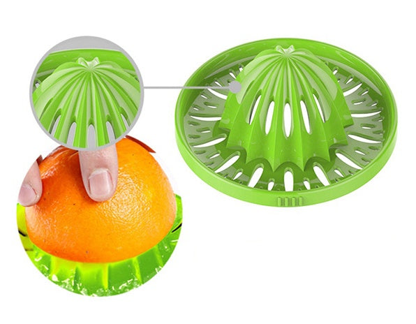 Green citrus reamer with an orange being juiced on a white background