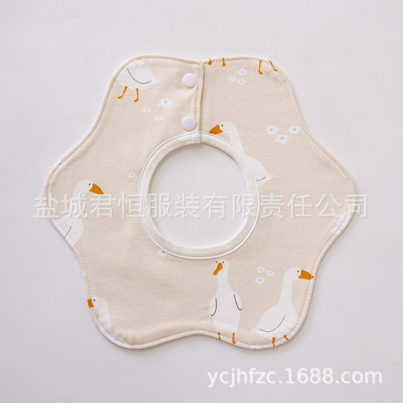 Beige bib with cartoon duck design on a light gray background