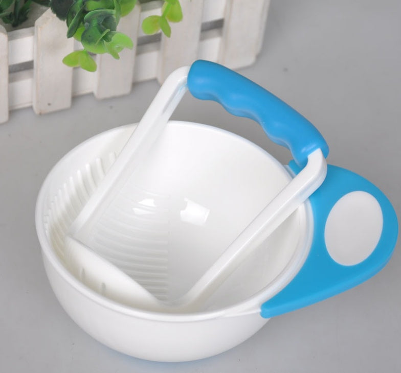 White kitchen tool with blue handle on a light gray surface