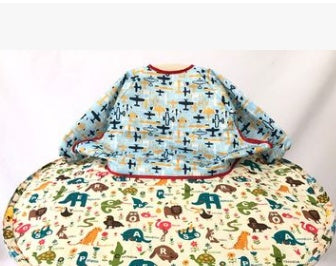 Baby outfit with patterned shirt and seat cover on a white background