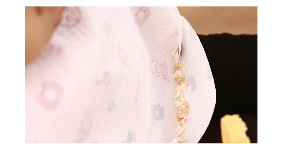 Close-up of a pink fabric with a gold necklace draped over it