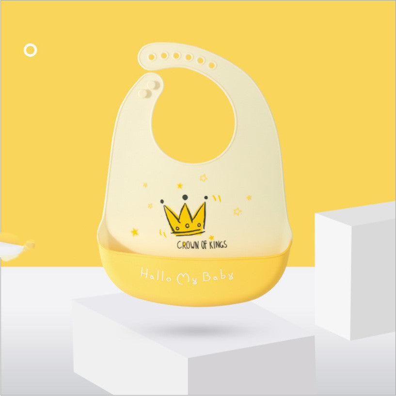 Yellow bib with a crown design on a white platform against a yellow background