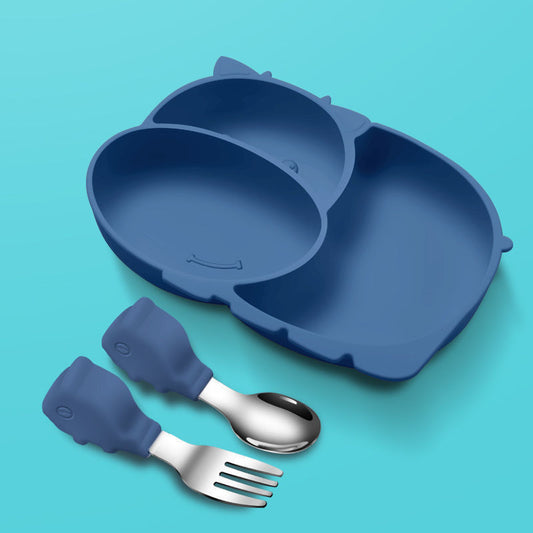 Blue silicone plate with fork and spoon on a teal background