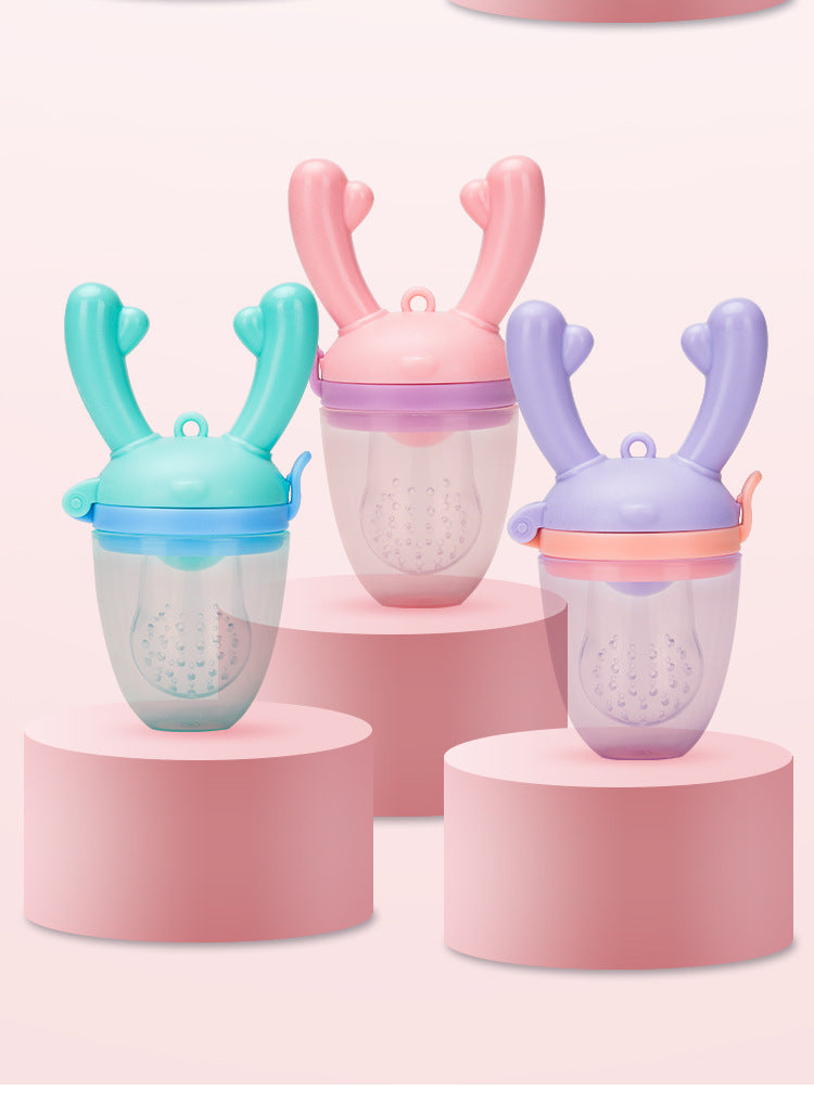 Three colorful baby food feeders on pink stands against a white background