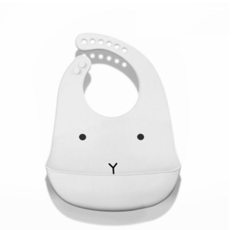 White silicone bib with a cartoon face design on a white background