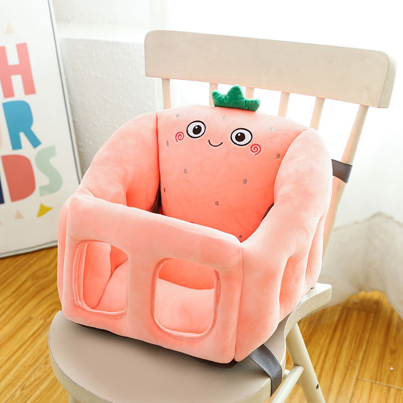 Pink cartoon character seat booster on a chair with a colorful alphabet poster in the background.