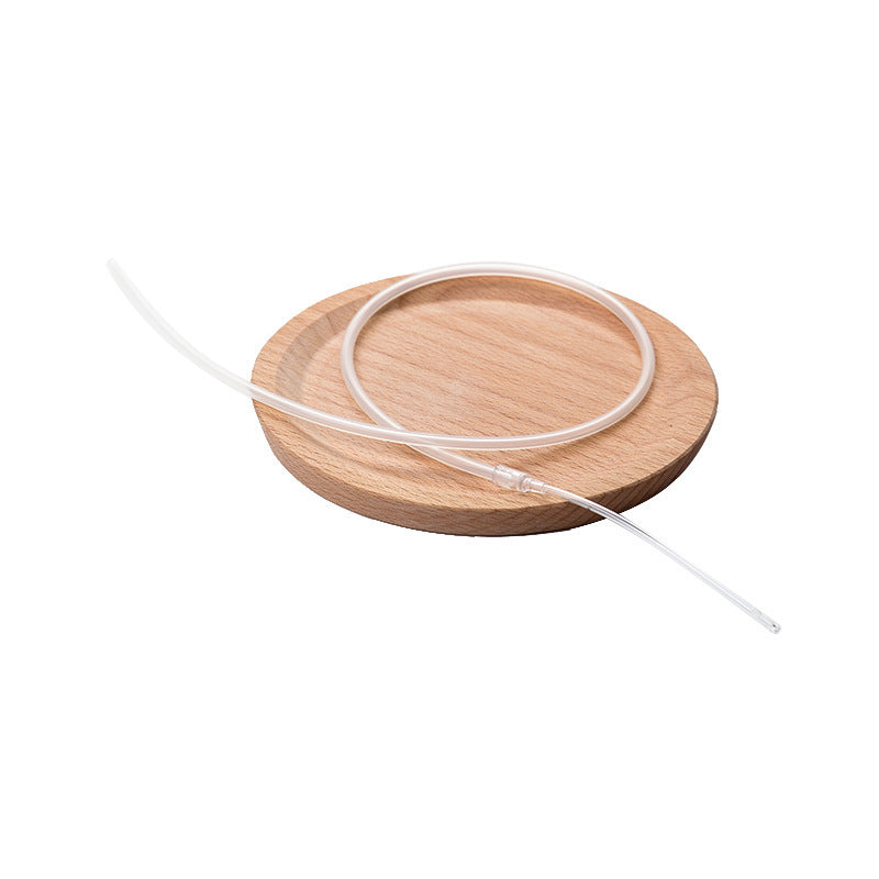 Wooden coaster with a clear glass drink holder on a white background
