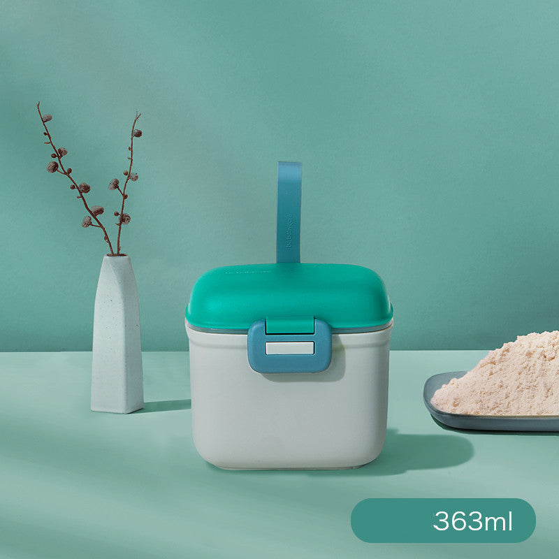 White and teal container with a green lid on a light green background