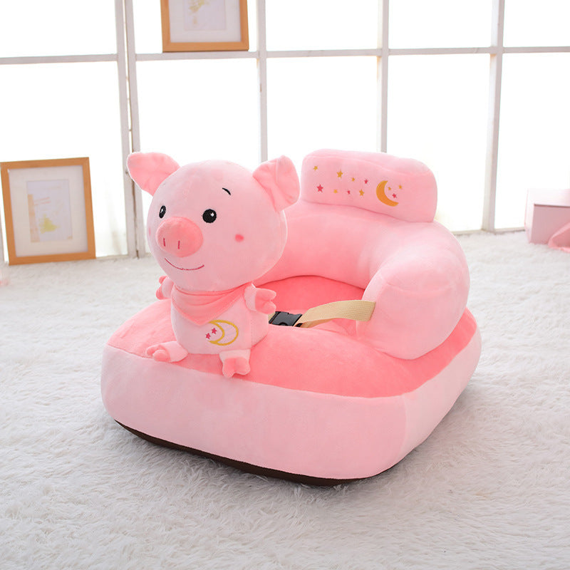 Pink pig-shaped children's chair on a light gray floor with a white wall in the background.