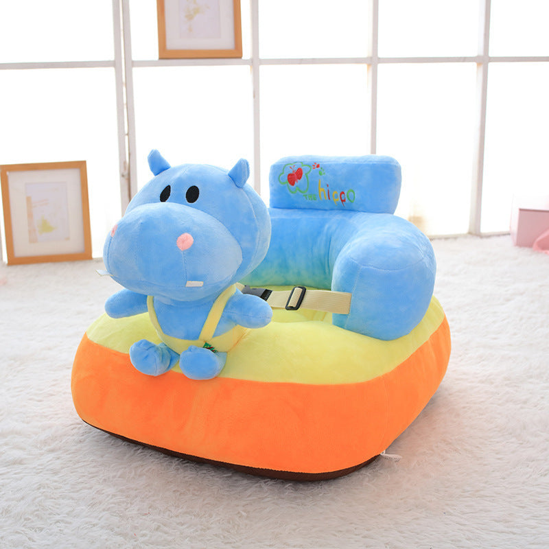 Children's toy seat with a blue hippo design on an orange base, placed indoors.