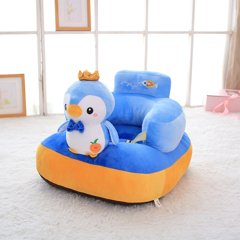 Children's plush chair shaped like a boat with a penguin figure on a white carpet.