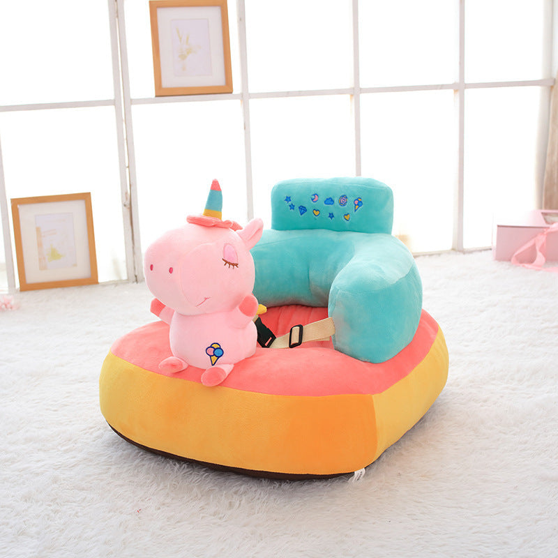 Colorful children's chair with a pink unicorn plush toy on a light gray floor.