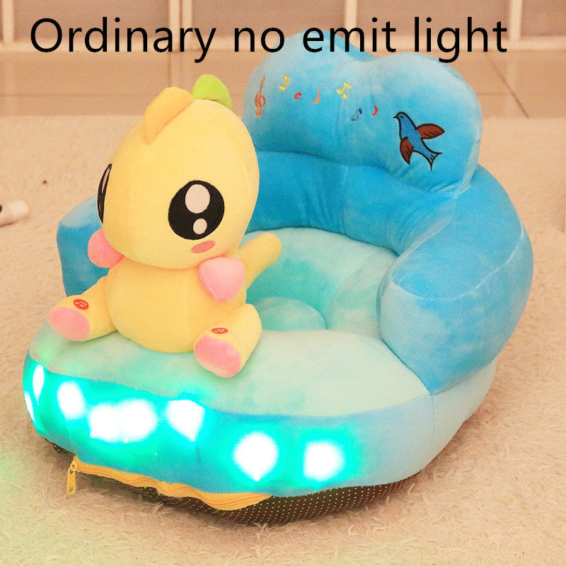 Children's inflatable seat with a cartoon character and LED lights on a beige floor.