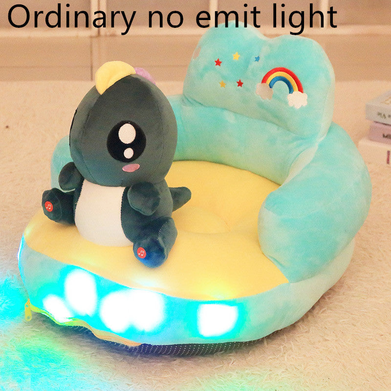 Children's inflatable seat with a penguin plush toy and LED lights on a beige surface.