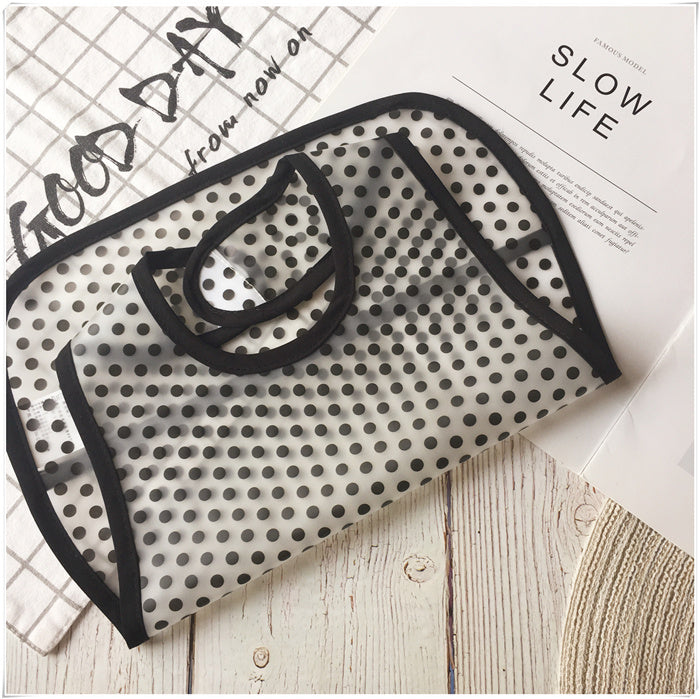Black and white polka dot towel on a wooden surface with text in the background