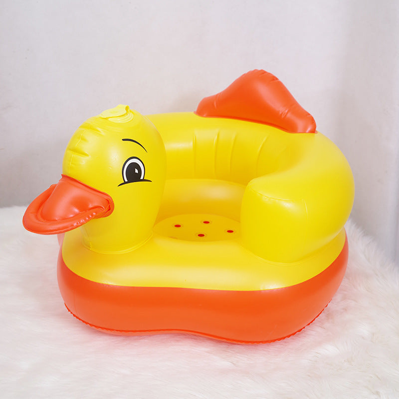 Inflatable yellow duck chair with a red beak and feet on a white background