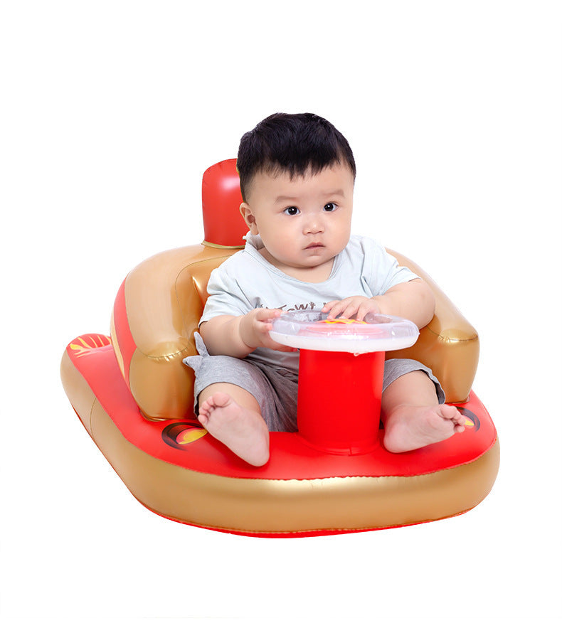 Baby sitting in a red and gold inflatable chair on a white background