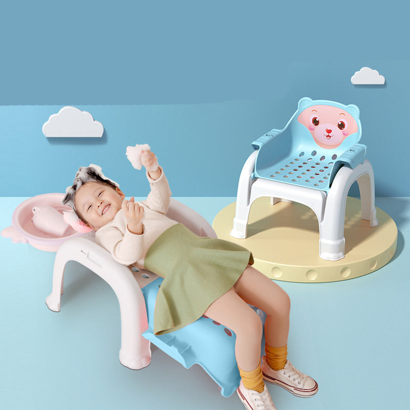 Child sitting on a colorful chair with cartoon face design against a blue background