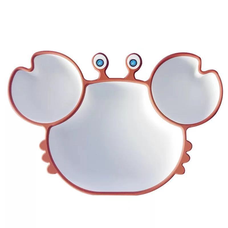 Crab-shaped plate with blue eyes on a white background