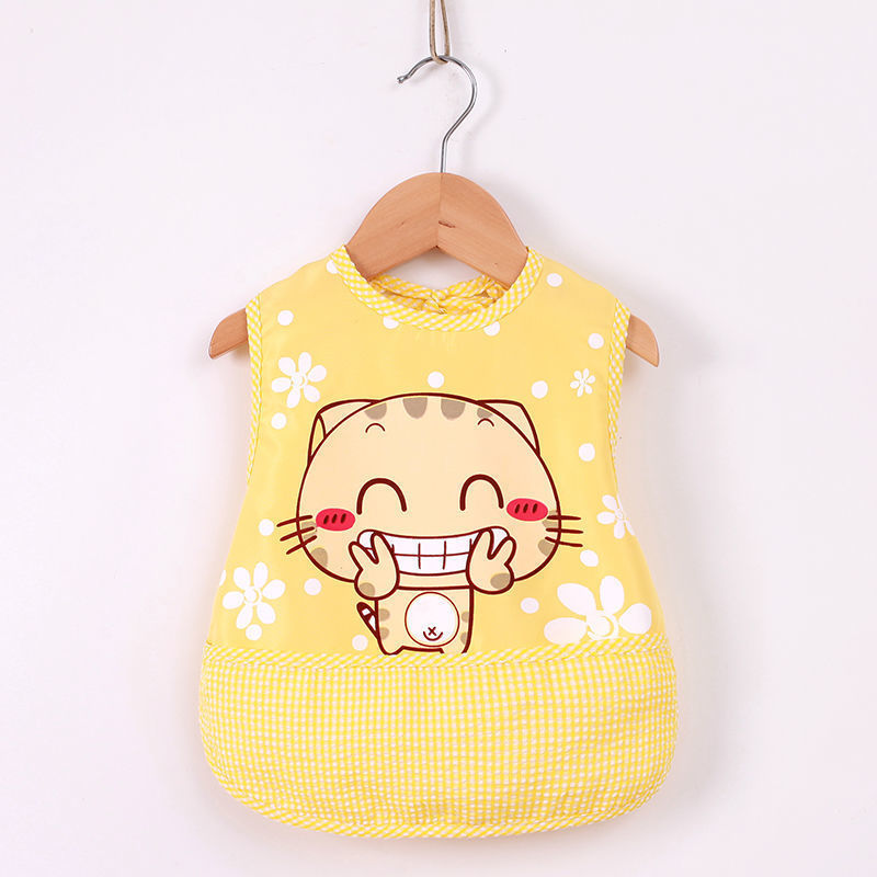 Yellow baby bib with cartoon cat design on a wooden hanger against a white background