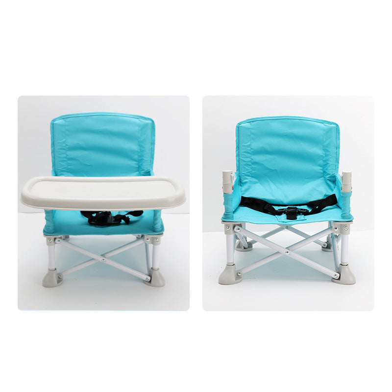 Two turquoise folding chairs with white trays on a white background