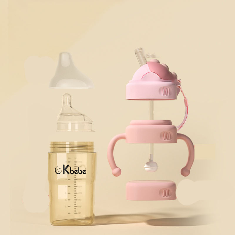 Baby bottle and pink sippy cup with Kbebe branding on a beige background