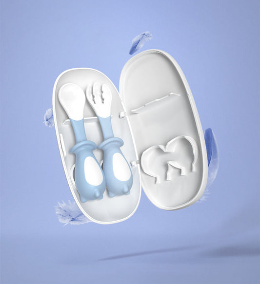 Set of baby utensils in a white case on a light blue background