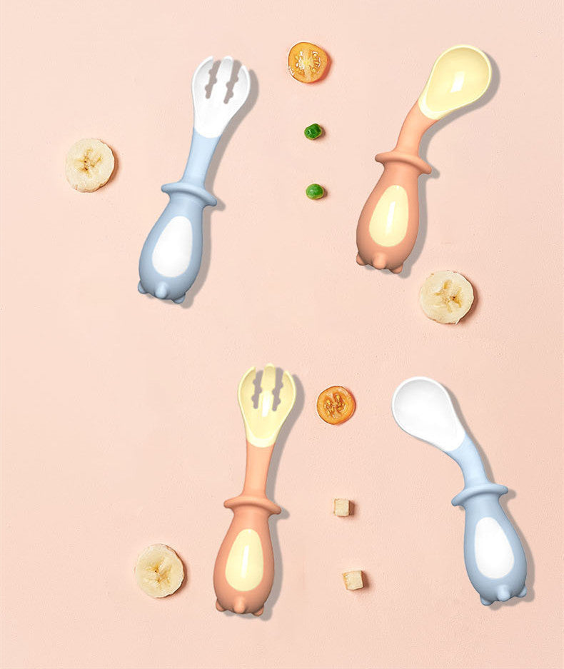 Set of baby utensils including spoons and a fork on a pink background with food items.