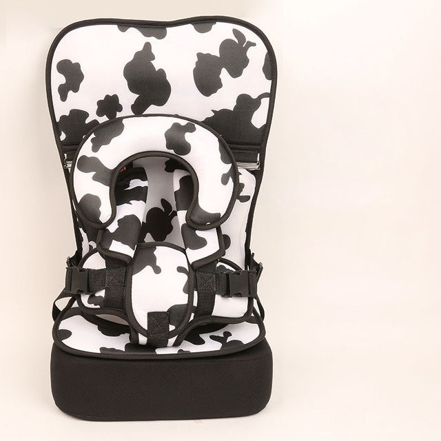 Baby carrier with black and white butterfly pattern on a beige background
