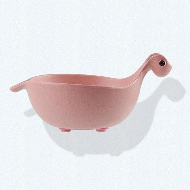 Pink ceramic bowl shaped like a fish on a white background
