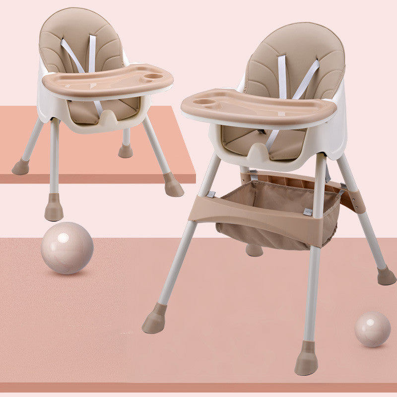 Beige and white high chair with tray on a pink and peach striped background