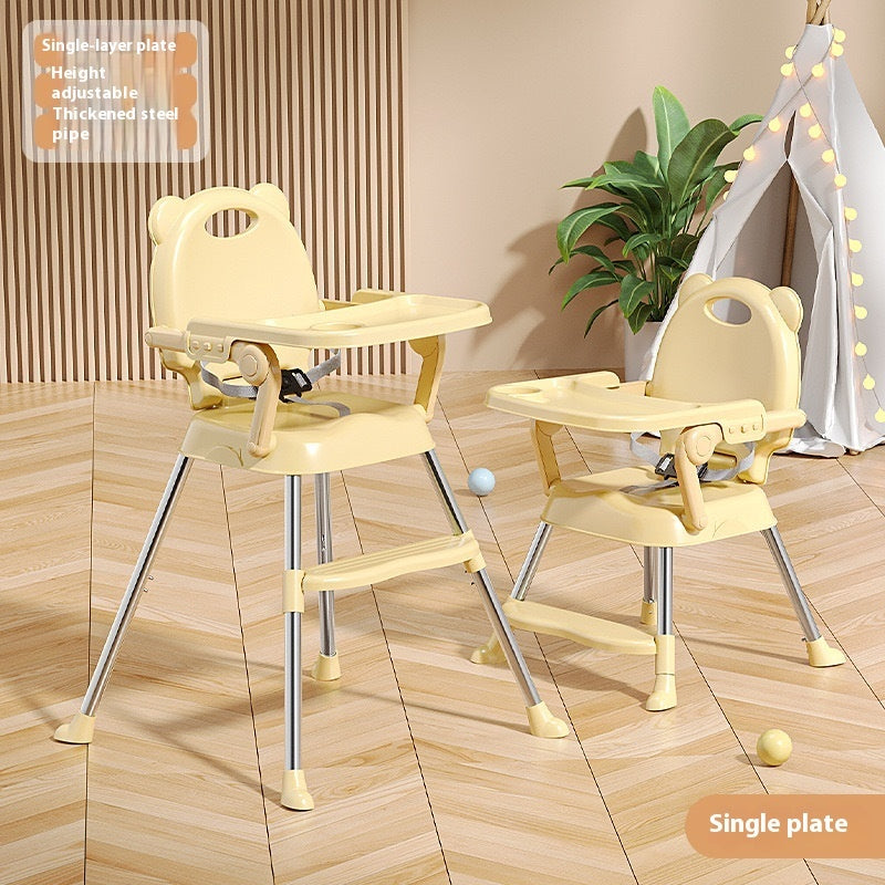 Two adjustable high chairs on a wooden floor with a plant in the background.