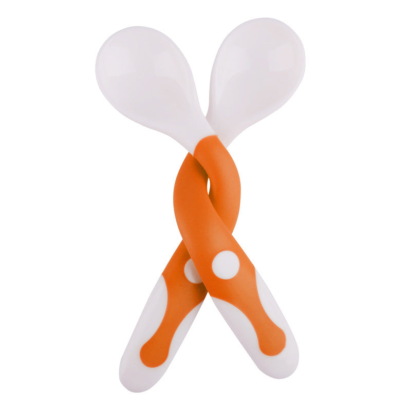 Pair of orange and white maracas on a white background