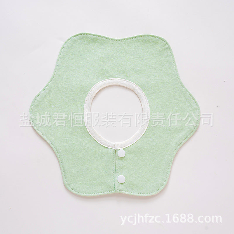 Light green fabric collar with white buttons on a light gray background