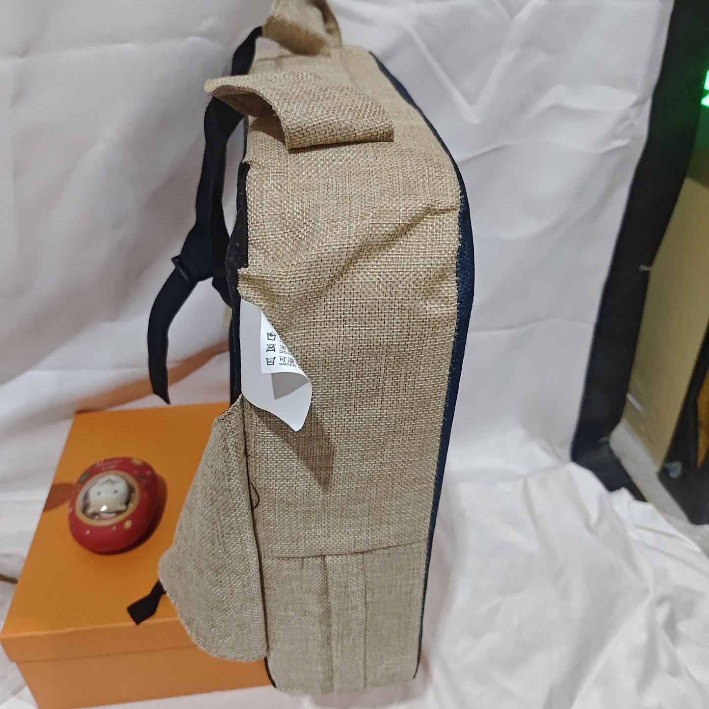 Beige bag with a tag on a white background
