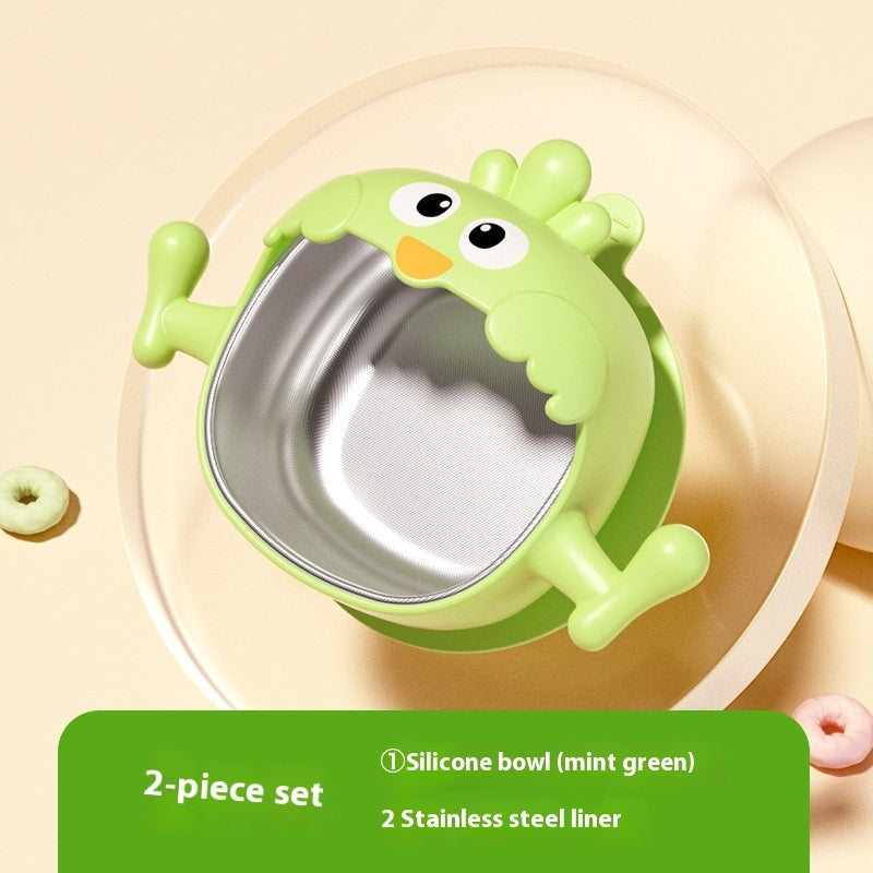 Green silicone bowl with stainless steel liner on a beige background