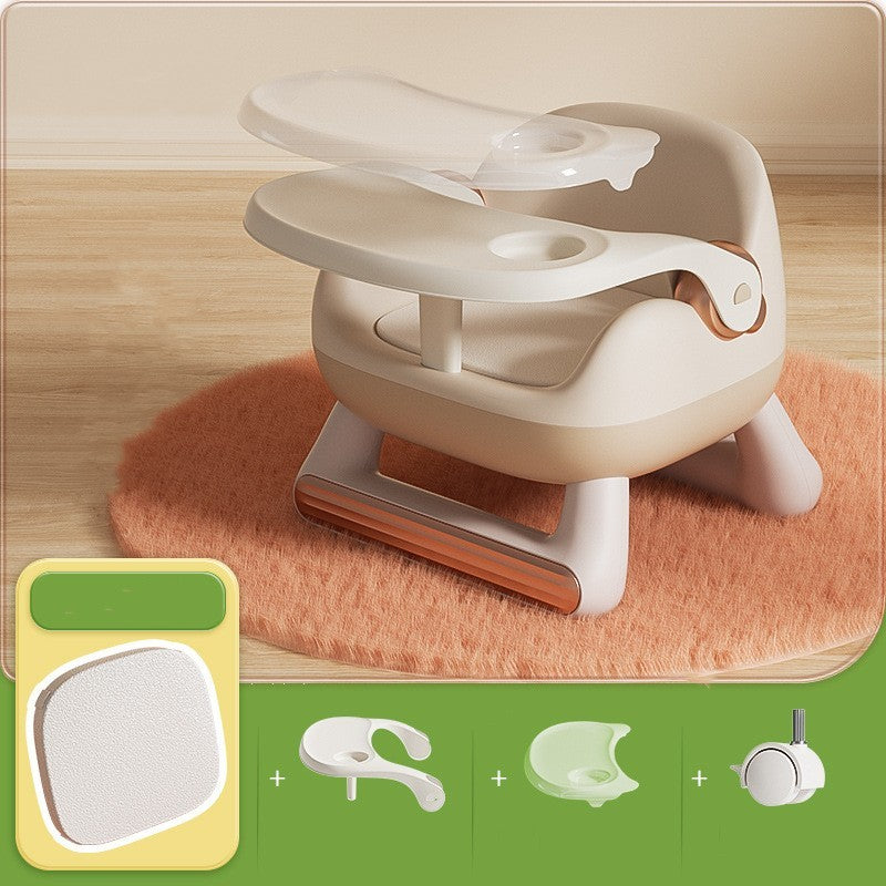 Child's toilet training seat on a wooden floor with accessories displayed below.
