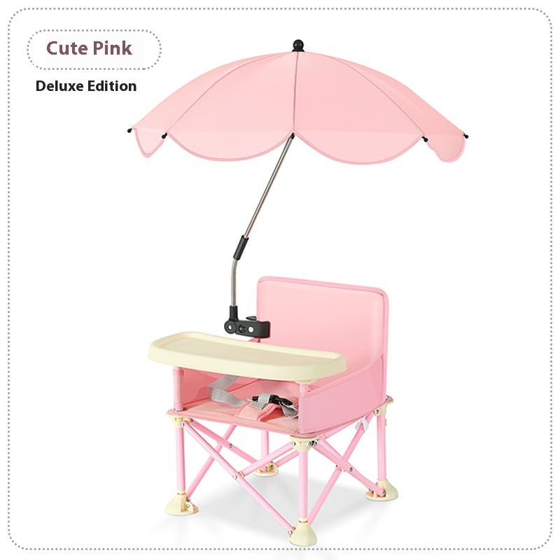 Pink children's chair with umbrella and desk on a white background