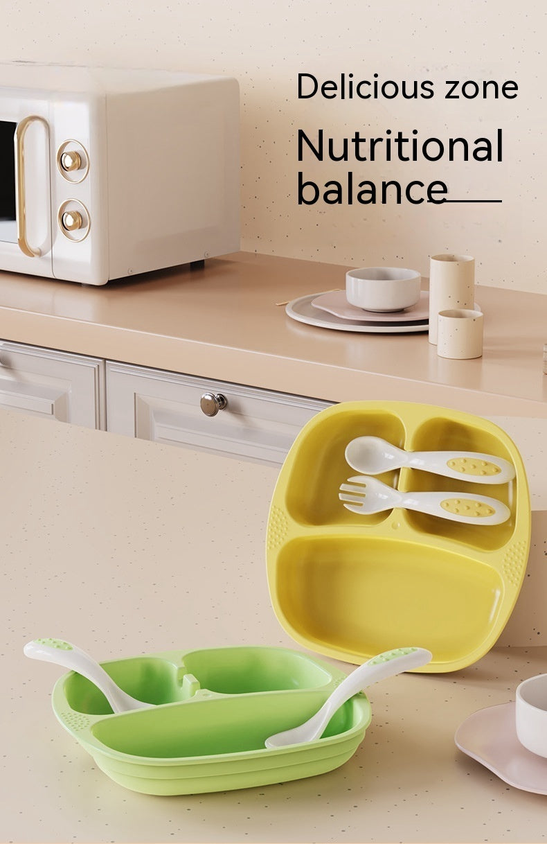 Yellow and green children's plate set with utensils on a kitchen counter.