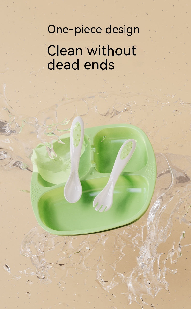 Green silicone mat with cutouts for a fork and spoon, splashing water on a beige background.